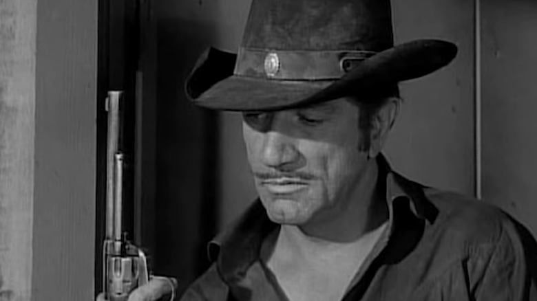 Paladin takes a look at his sidearm on Have Gun — Will Travel (1957-1963)