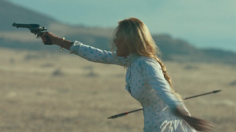 Elsa aims a gun