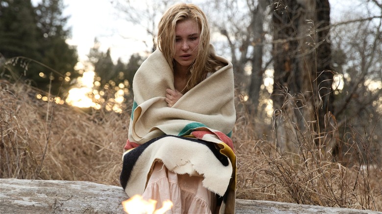 Elsa huddled in blanket by fire