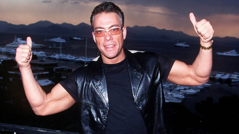 Jean-Claude Van Damme in sunglasses giving two thumbs ups