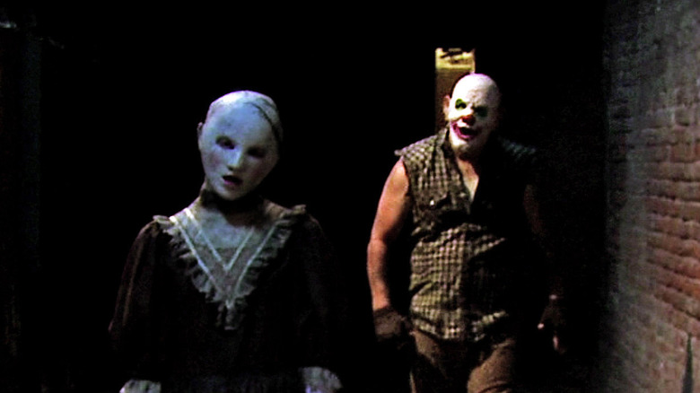Two haunt performers stalk group