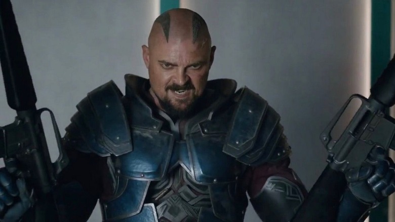 Skurge holding up guns