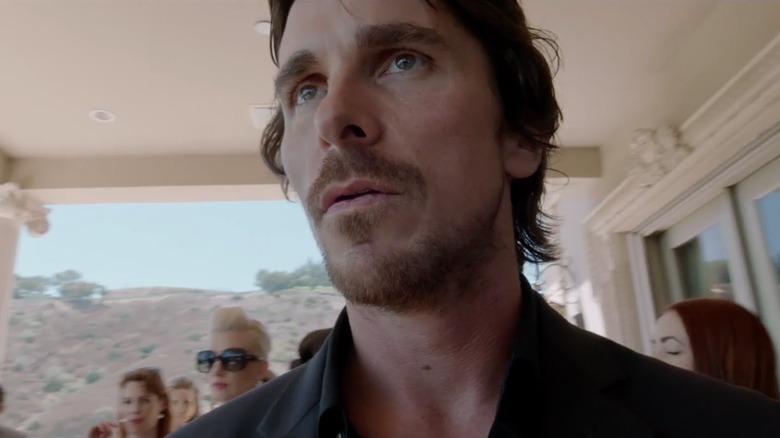 Rick looking dazed at a party in "Knight of Cups" (2016)