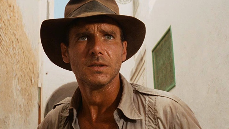 Indiana Jones looking concerned during a chase in "Raiders of the Lost Ark" (1981)