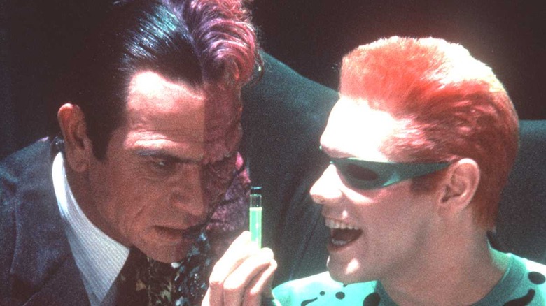 Two Face and Riddler look at vial