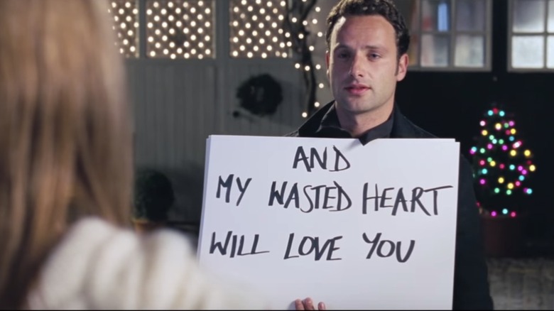 Andrew Lincoln holds cards