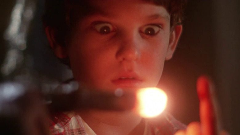 Elliot looking at E.T..'s glowing finger