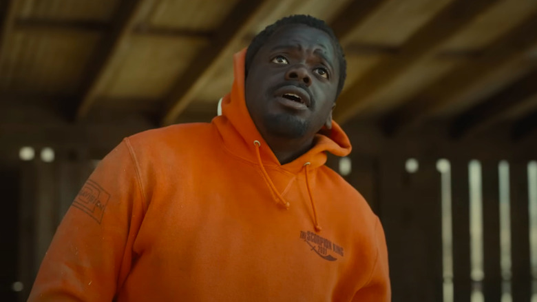 OJ looking up in orange sweatshirt