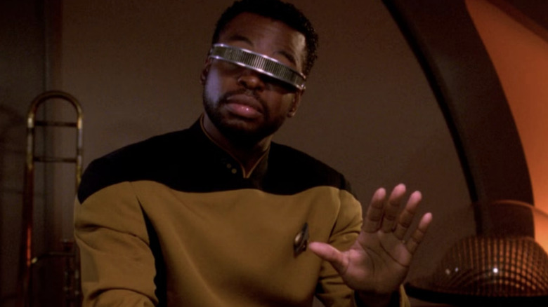 Geordi holds up his hand in Star Trek: The Next Generation