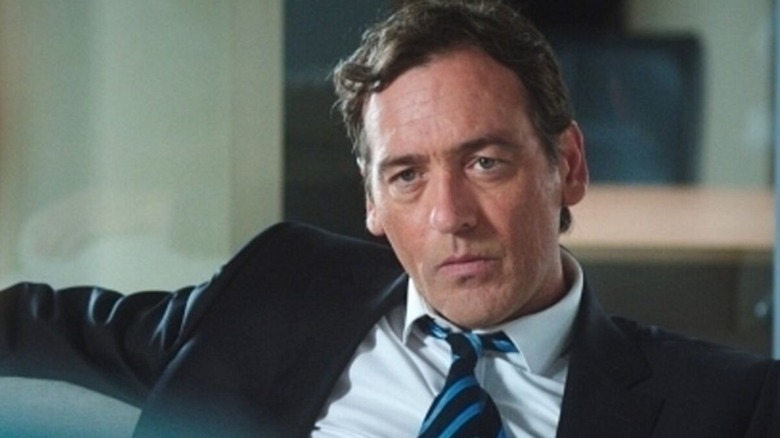 Brian Lenihan listening intently in "The Guarantee" (2014)