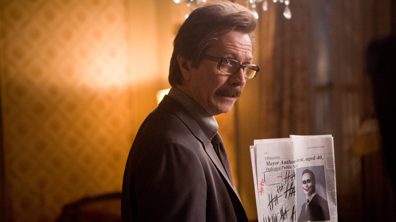 Commissioner Gordon holding Joker evidence in "The Dark Knight" (2008)