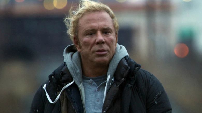 Robin walks on the street in a coat