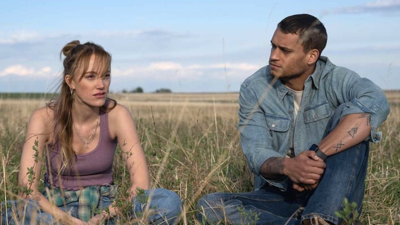 Kenna and Ledger sitting in a field in 