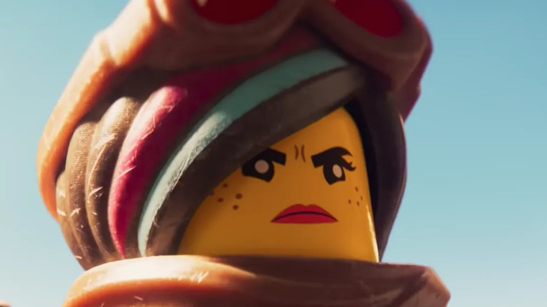 A lego woman looks right