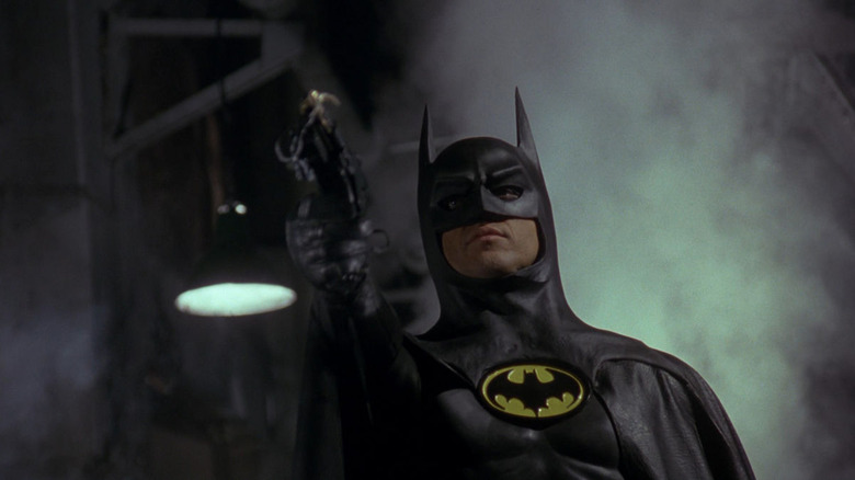 Batman aiming his grappling hook upward in Batman (1989)
