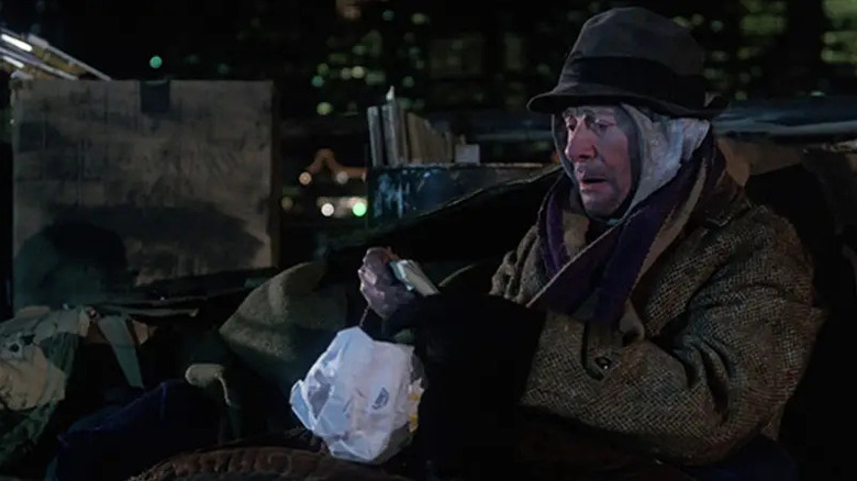 Mortimer holds a wad of cash in "Coming to America" (1988)