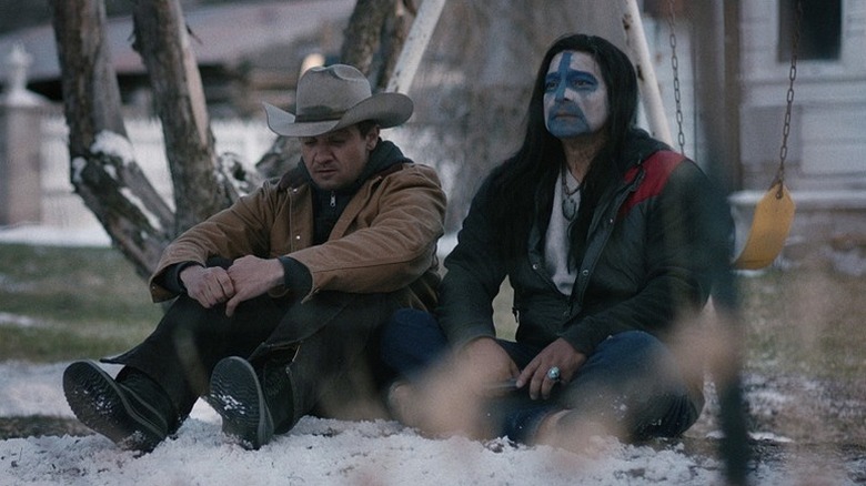 Cory Lambert and Martin Hanson sit in the snow in "Wind River" (2017)