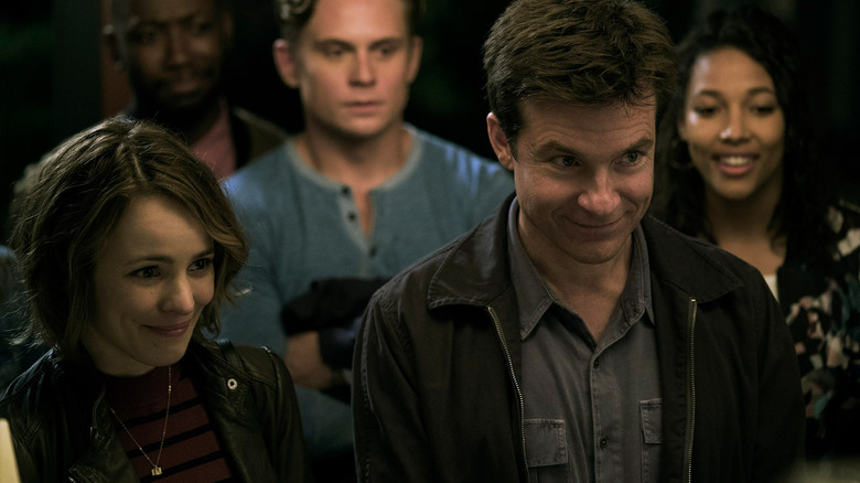 Annie, Max, Kevin, Ryan, and Michelle stand in a doorway in "Game Night" (2018)