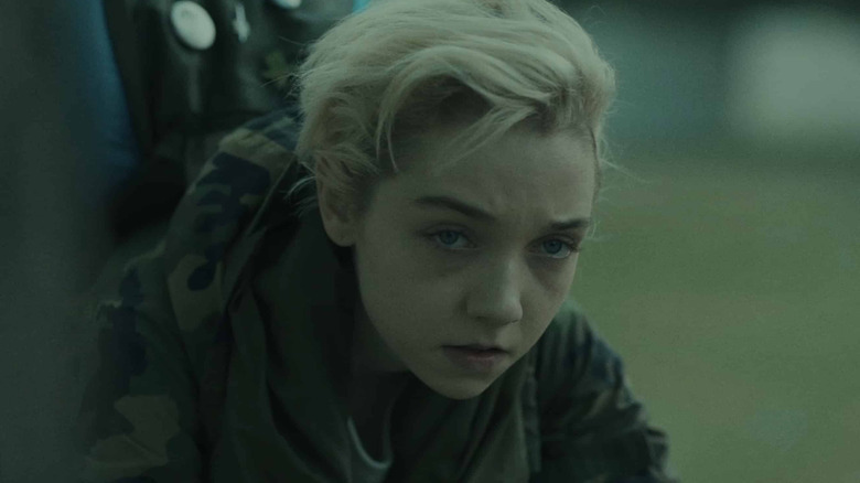 Sarah leans from a window in Come True (2021)