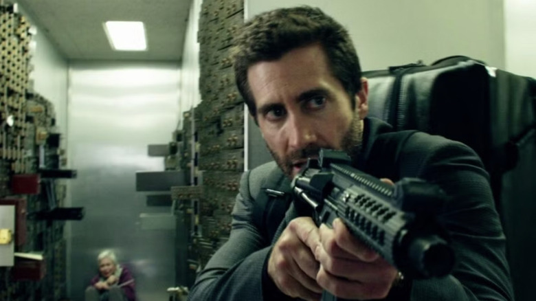 Danny aims a machine gun inside a bank vault in "Ambulance" (2022)