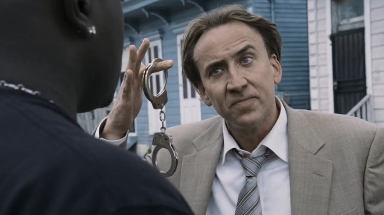 McDonagh holds up a pair of handcuffs in "Bad Lieutenant: Port of Call New Orleans" (2009)