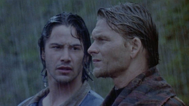 Johnny Utah looking over at his mentor Bodhi while standing out in the rain in "Point Break"