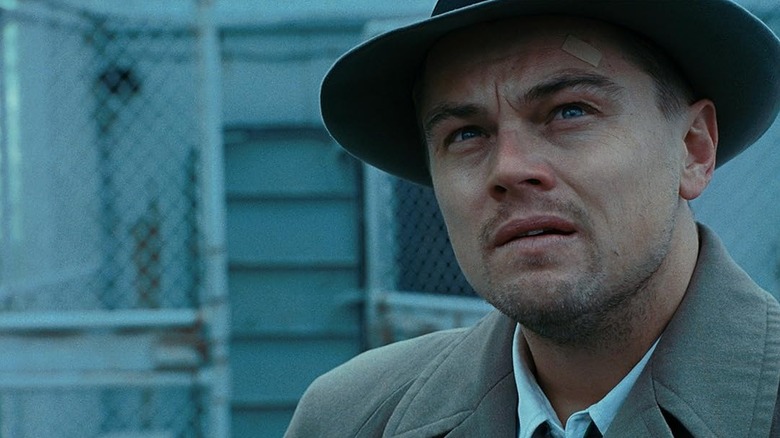 Teddy with a bandage on his head looking up at somethig in Shutter Island