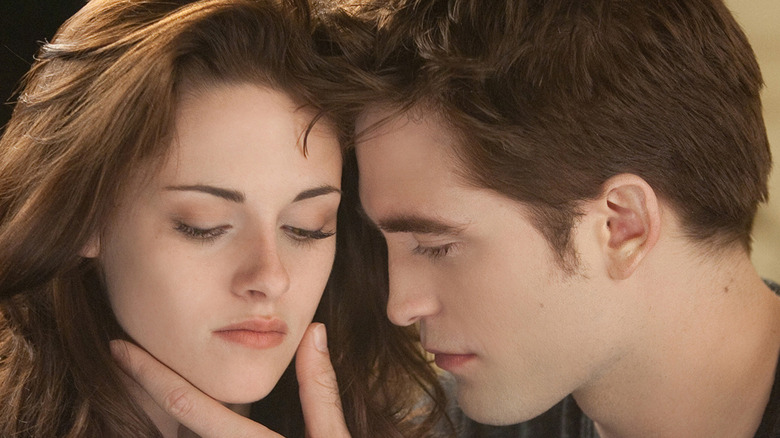 Bella Swan (Kristen Stewart) and Edward Cullen (Robert Pattinson) share an intimate embrace.