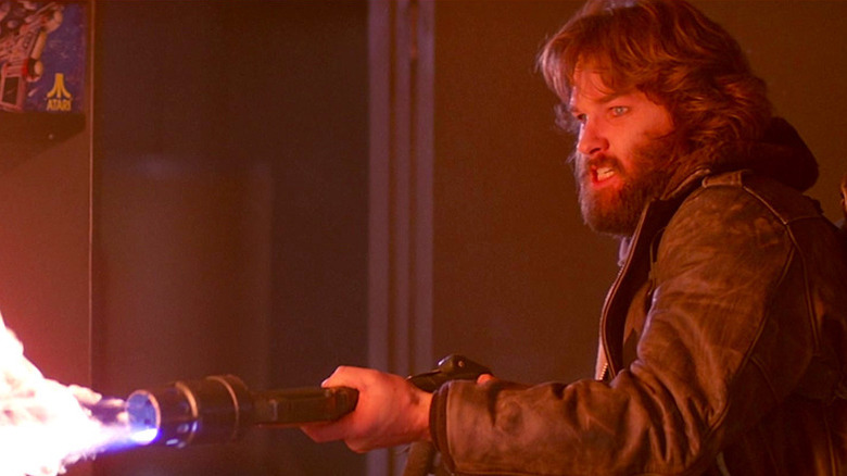 MacReady shooting a flamethrower in The Thing (1982)