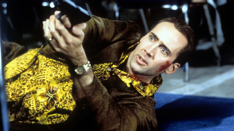 Rick lying down pointing gun
