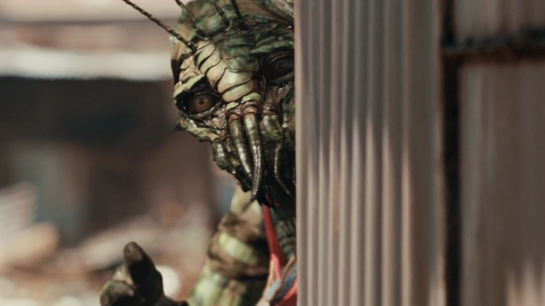 Alien peering out from behind wall