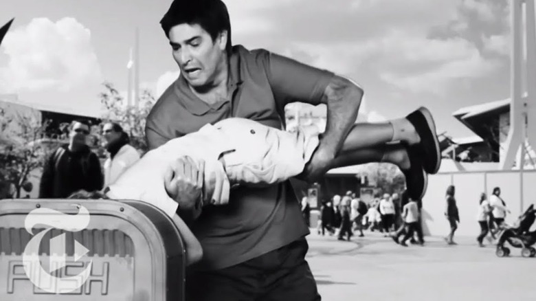 Roy Abramsohn holding a child