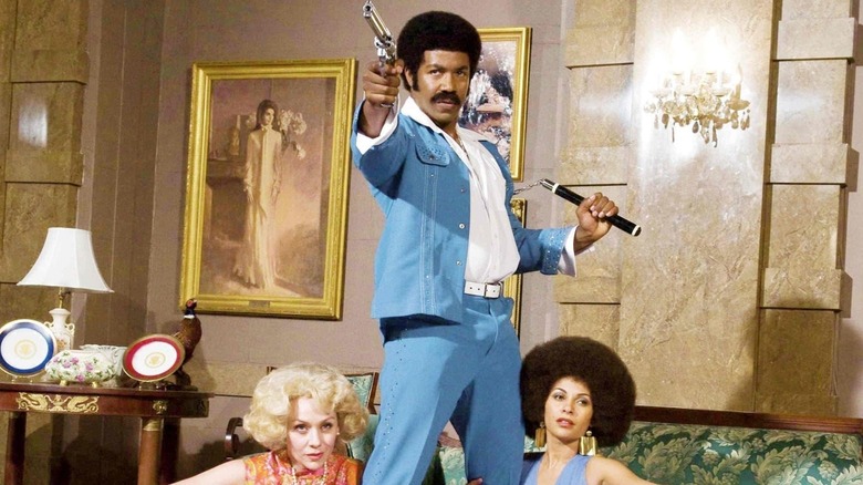 Michael Jai White with two women and a gun