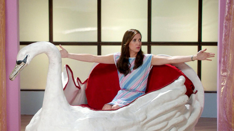 Kristen Wiig rides in a plastic swan