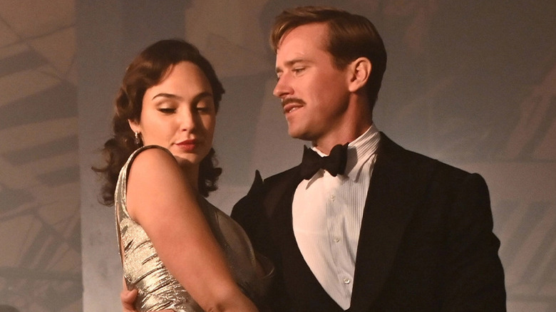 Army Hammer holds Gal Gadot to him
