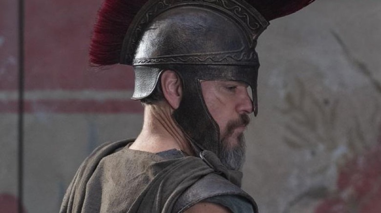 Odysseus stands in armor in "The Odyssey" (2026)