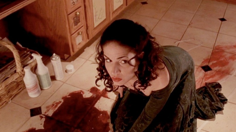 Gabriela cleans up blood from a kitchen floor in Curdled (1996)