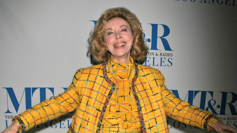 Dr Joyce Brothers smiles while tilting her head