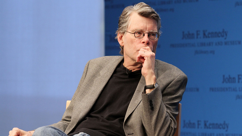Stephen King in gray suit at panel event