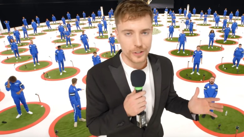 MrBeast talking into mic in front of contestants