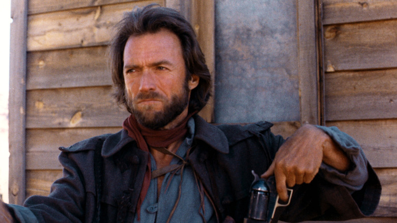 Josey Wales sits on a porch in "The Outlaw Josey Wales" (1975)