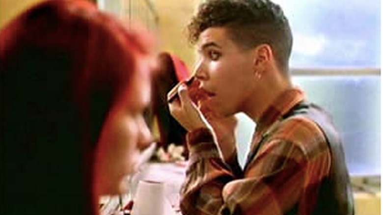Rickie putting on eyeliner in the girls' bathroom