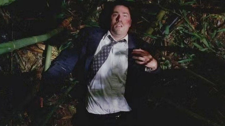 Jack lying on the ground in the woods in "Lost" (2004-2010)
