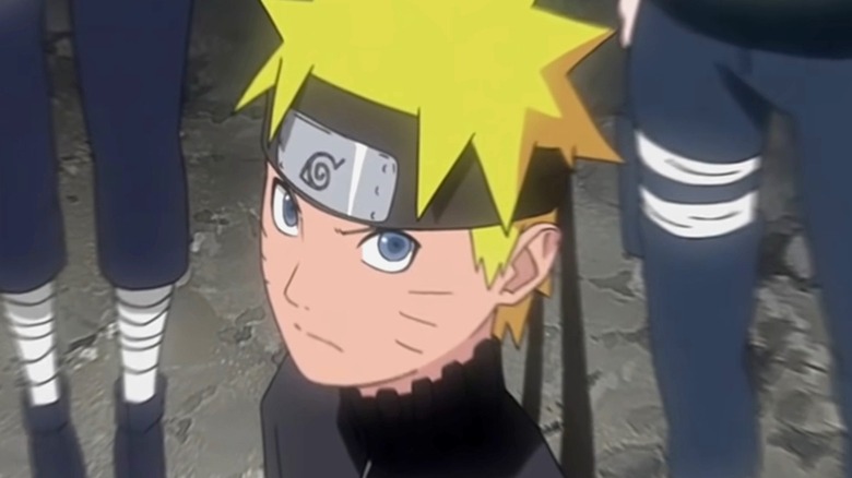 Naruto looks upwards with people behind him