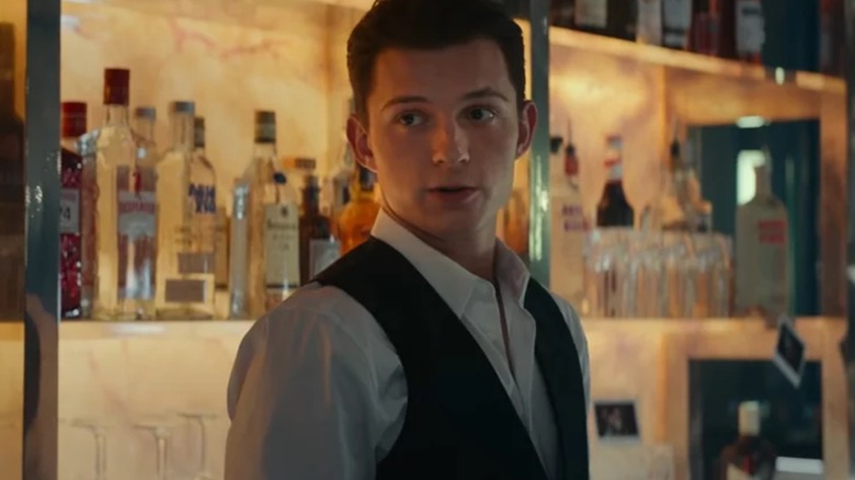 Nathan Drake standing behind bar in Uncharted (2022)