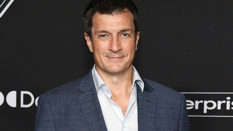 Nathan Fillion smirks