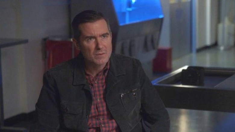 Jeremy Brighton stern face red plaid shirt