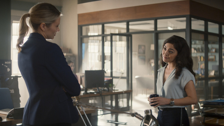 Kate and Lucy stand at the office