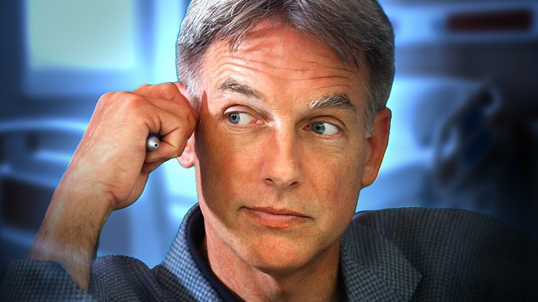 Leroy Jethro Gibbs holding a pen in his fist and looking thoughtful