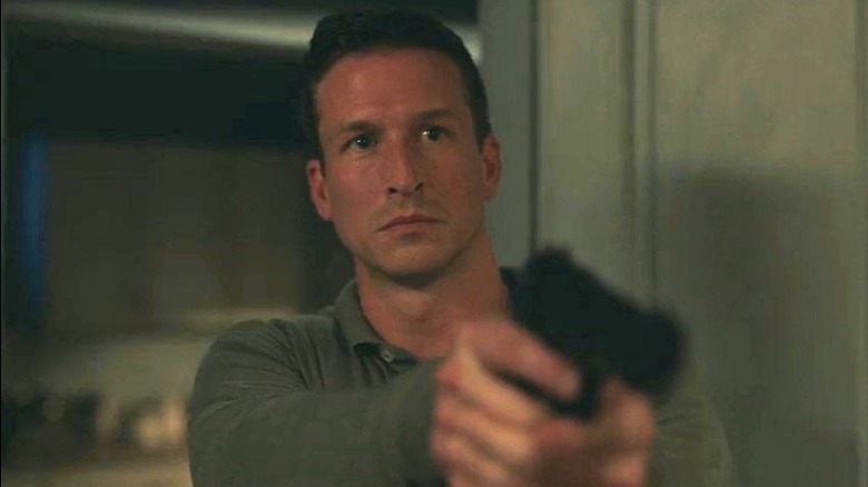 Luke Fletcher points a gun in "NCIS: Origins" (2025)